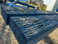 Two rectangular weathered gray concrete or stone pavers with a textured, rustic wood-grain finish, shown outdoors on a paved surface.